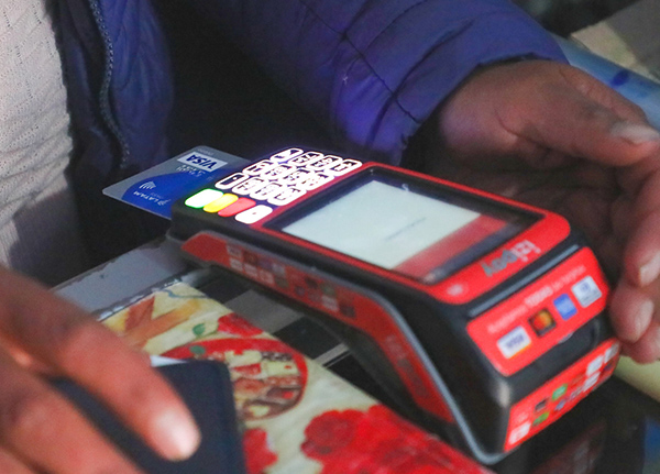 Credit card inserted into a payment system machine