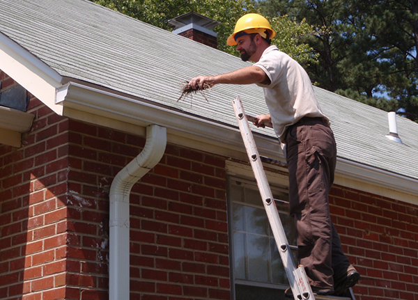 Man cleaning out gutters