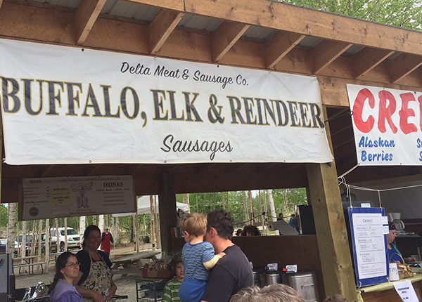 Outdoor stand selling buffalo, elk, and reindeer sausage