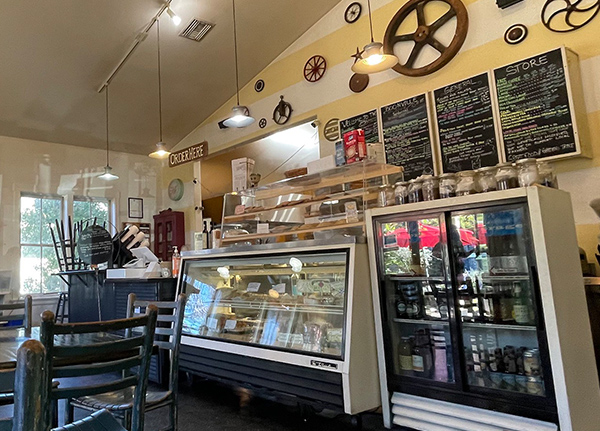 The inside of a small shop with food cases and wheels on the wall